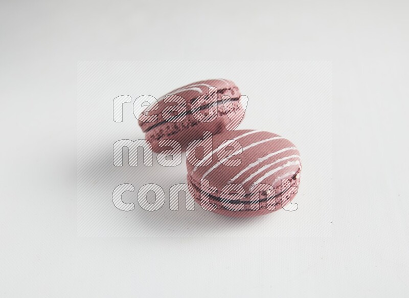 45º Shot of two Red Poppy Flower macarons on white background