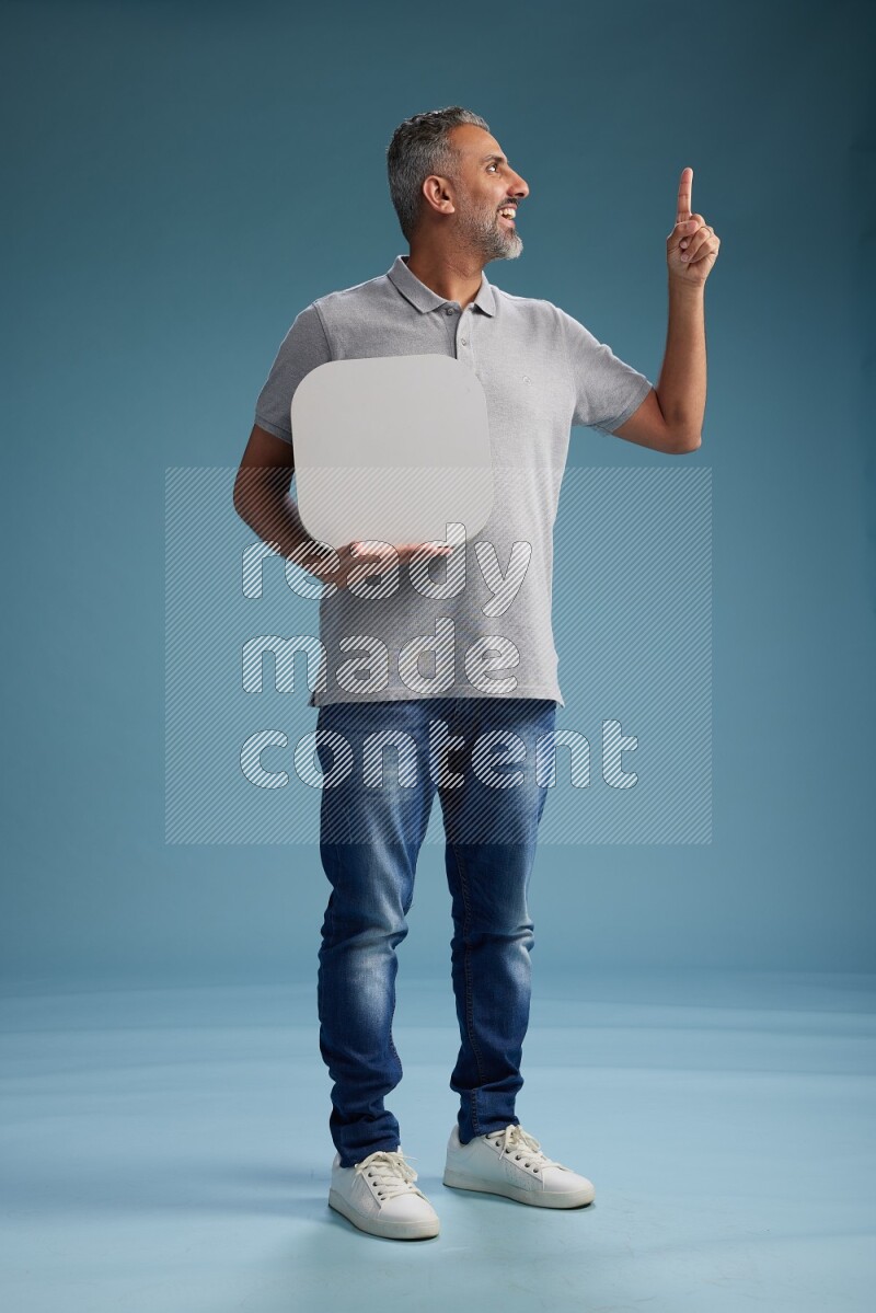 Man Standing holding social media sign on blue background