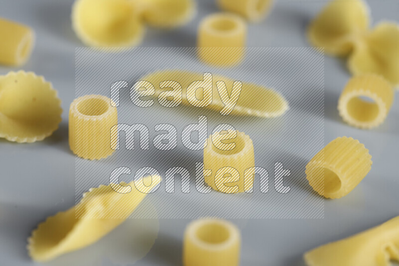 Different pasta types on light blue background