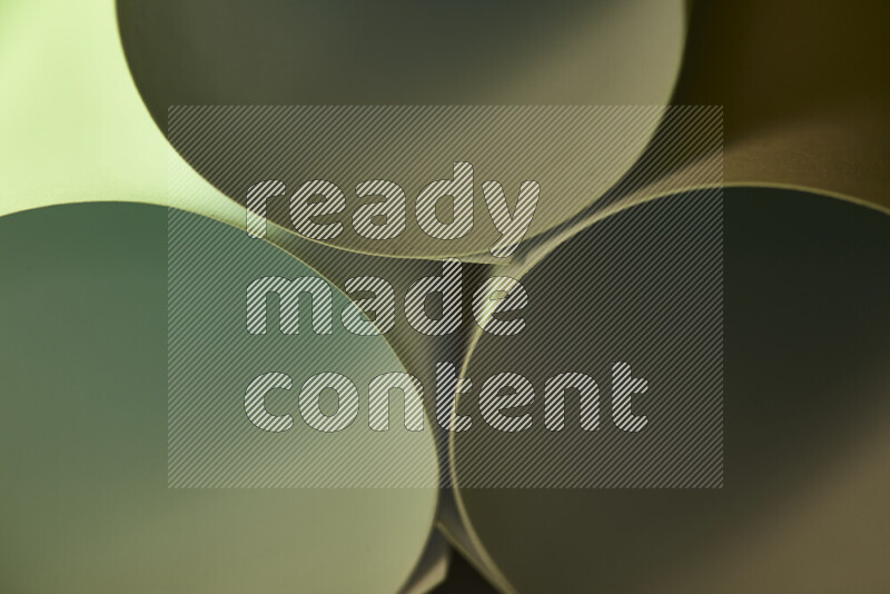 The image shows an abstract paper art with circular shapes in varying shades of green and warm tones