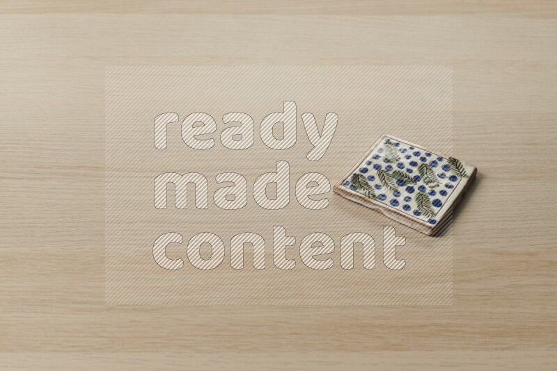 A decorative coaster on light wooden background