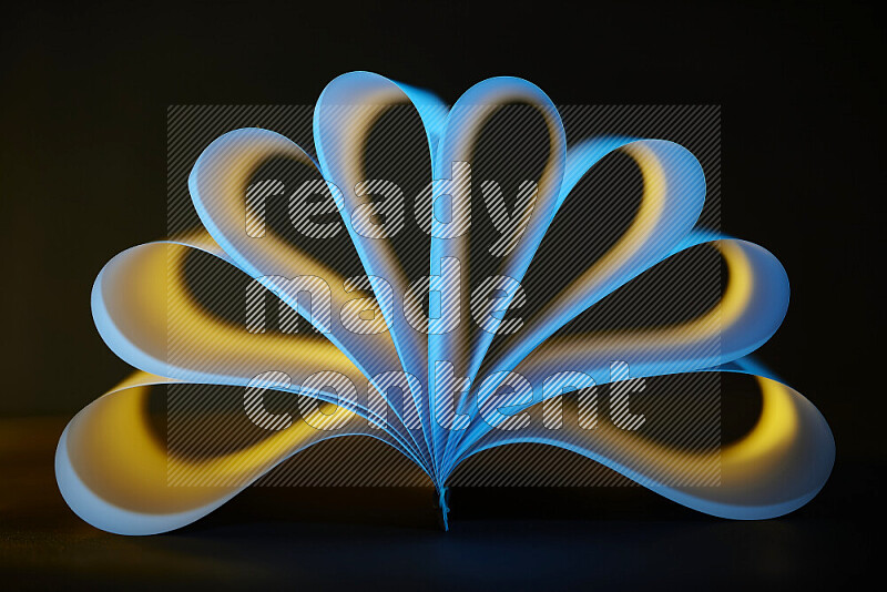 An abstract art piece displaying smooth curves in yellow and blue gradients created by colored light