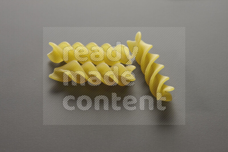 Fusilli pasta on grey background