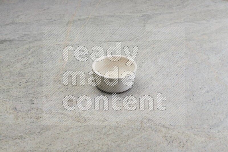 A white pottery bowl on grey marble background