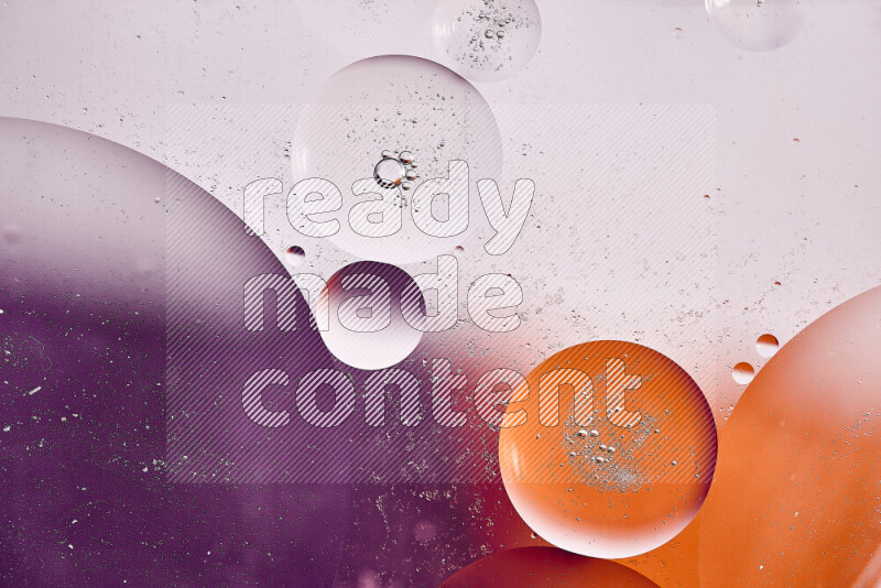 Close-ups of abstract oil bubbles on water surface in shades of white, orange and purple