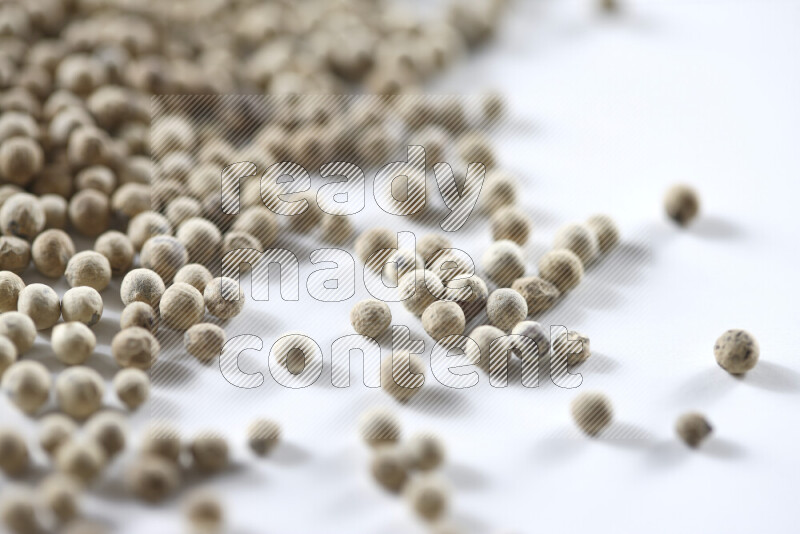 White pepper beads on white background