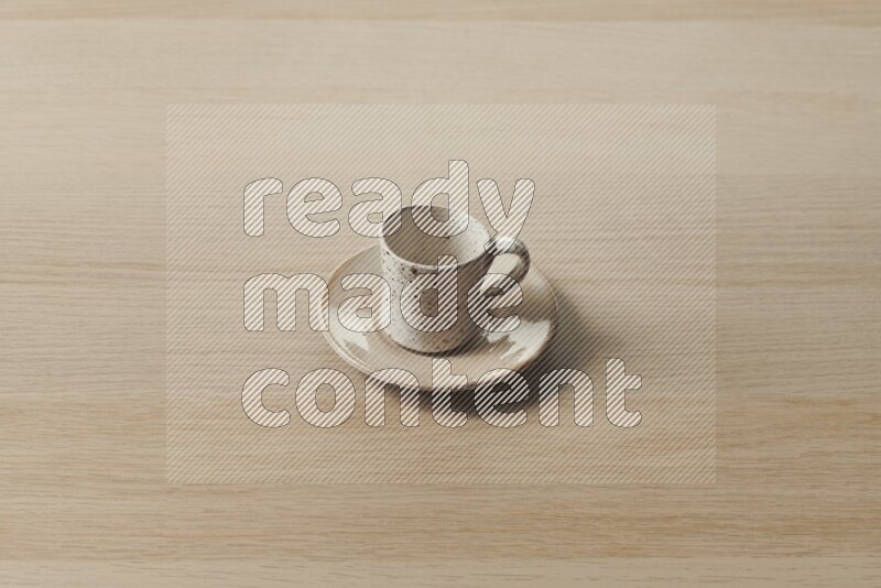 A pottery cup on light wooden background