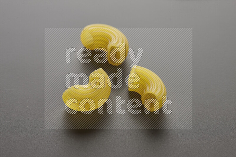 Elbow pasta on grey background