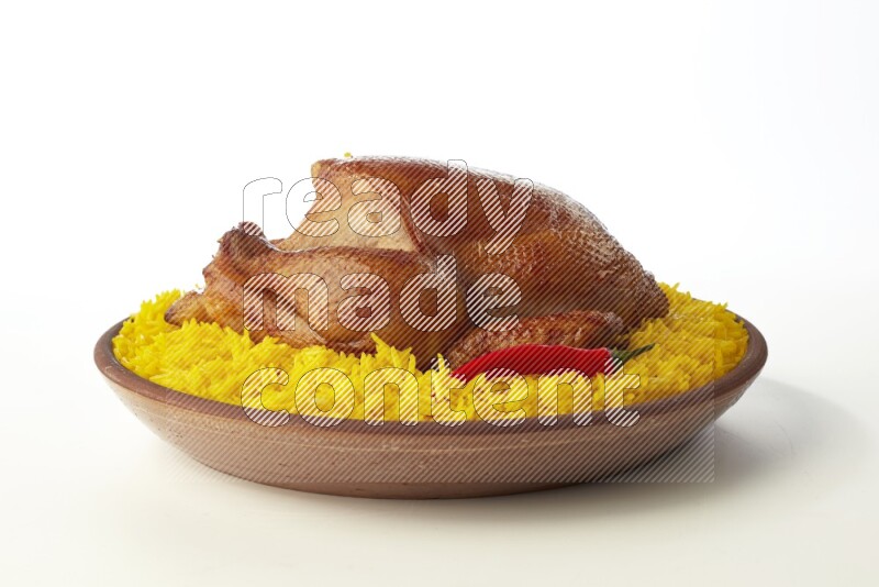 yellow basmati Rice with whole roasted chicken  on a pottery plate  direct  on white background