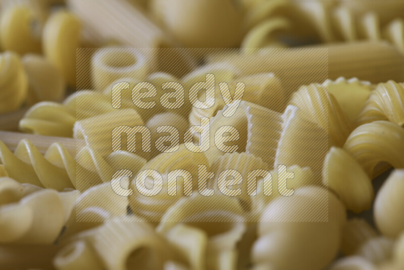 Different pasta types on light blue background