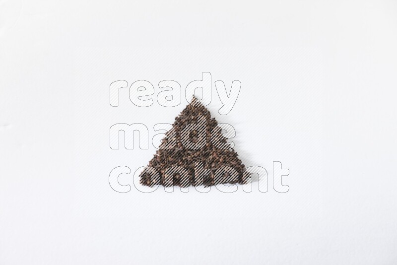 cloves in a triangle shape on a white flooring