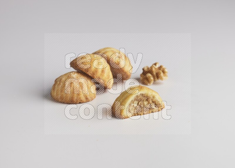 Four Pieces of Maamoul filled with walnut paste  one of them is cut direct on white background