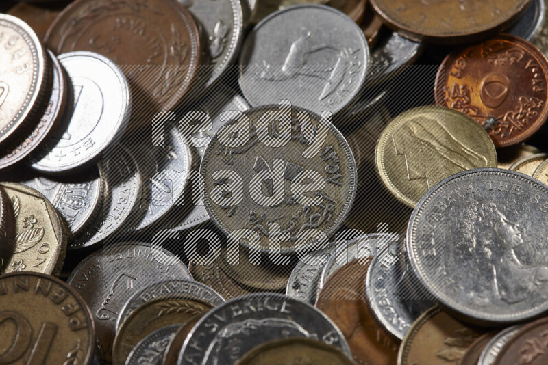 A close-ups of random old coins on black background