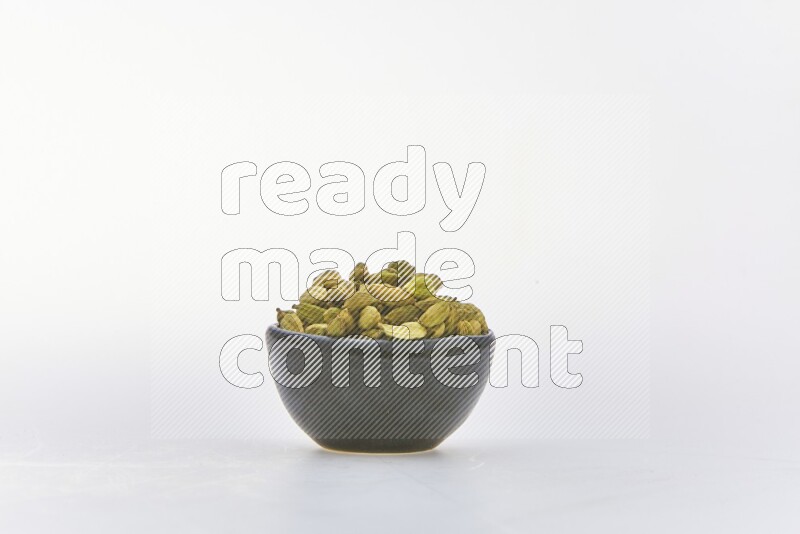 Cardamon in a container on white background
