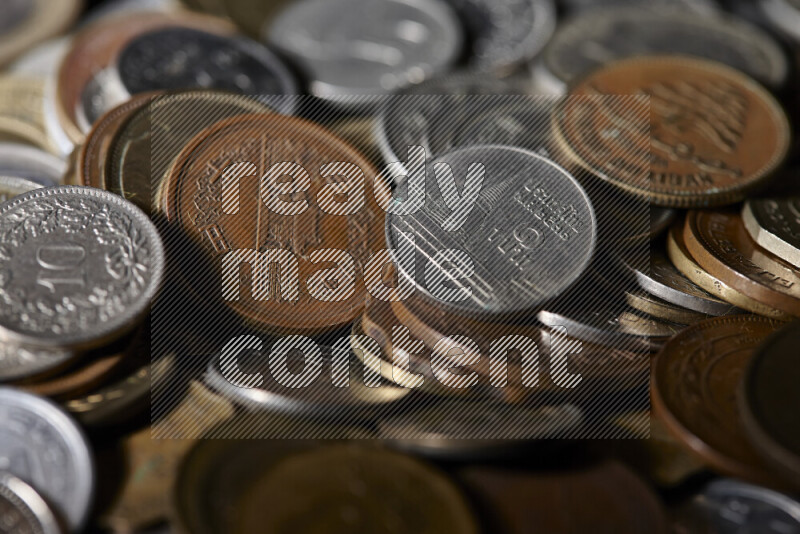 A close-ups of random old coins on black background