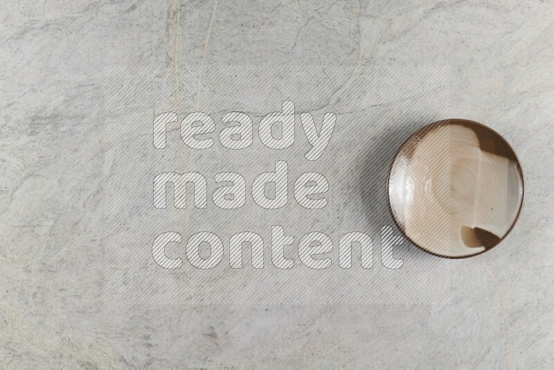 A multicolored pottery plate on grey marble background