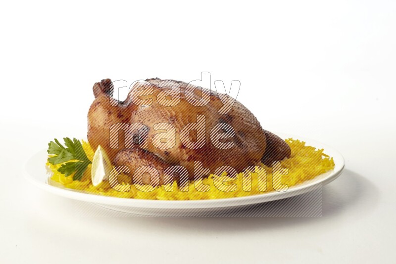 yellow  basmati Rice with  whole roasted chicken on a white rounded plate direct on white background