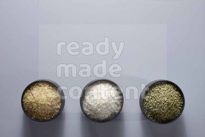 Legumes in pottery bowls on light grey background
