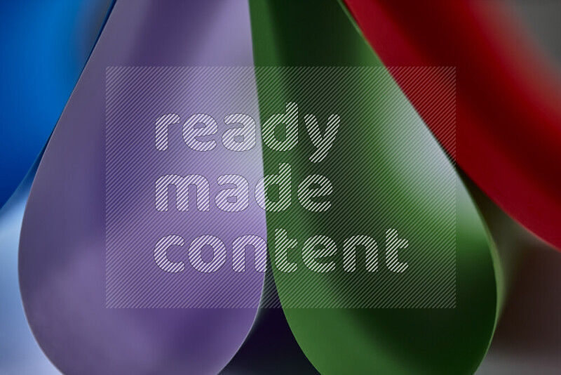 An abstract art showing colorful paper sheets arranged in an overlapping curves