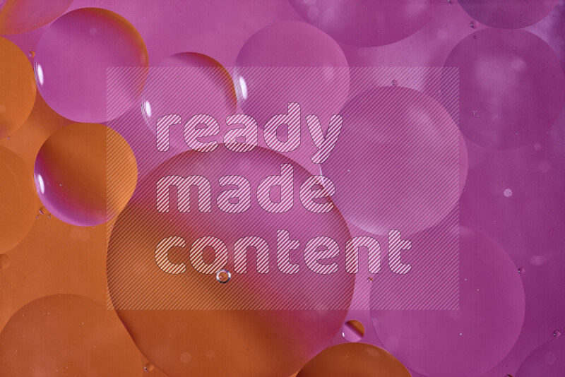 Close-ups of abstract oil bubbles on water surface in shades of orange and pink