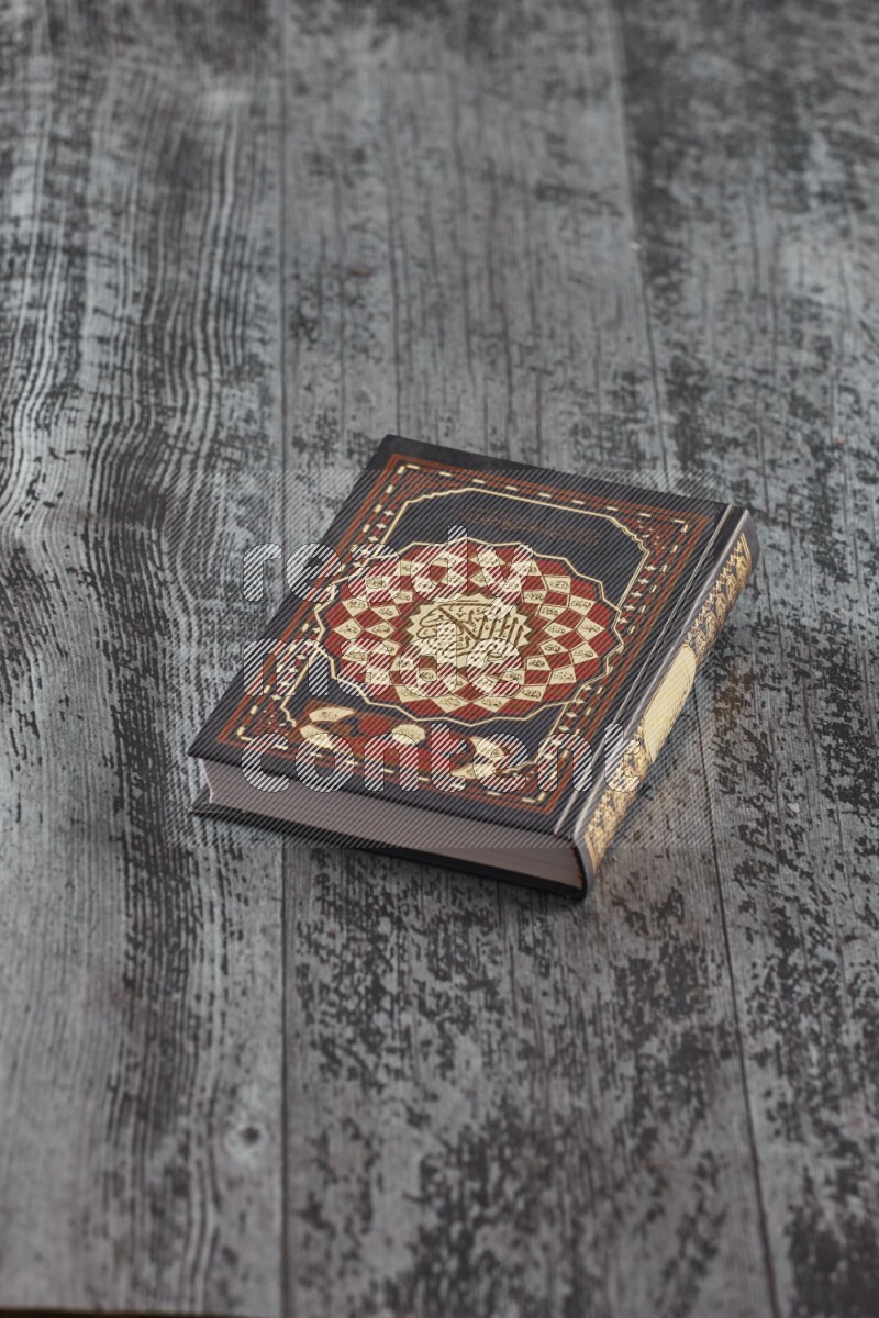 Quran with a prayer beads on wooden background
