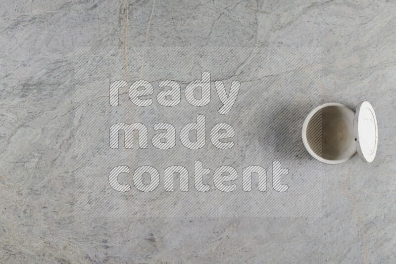 A multicolored pottery Cup on grey marble background