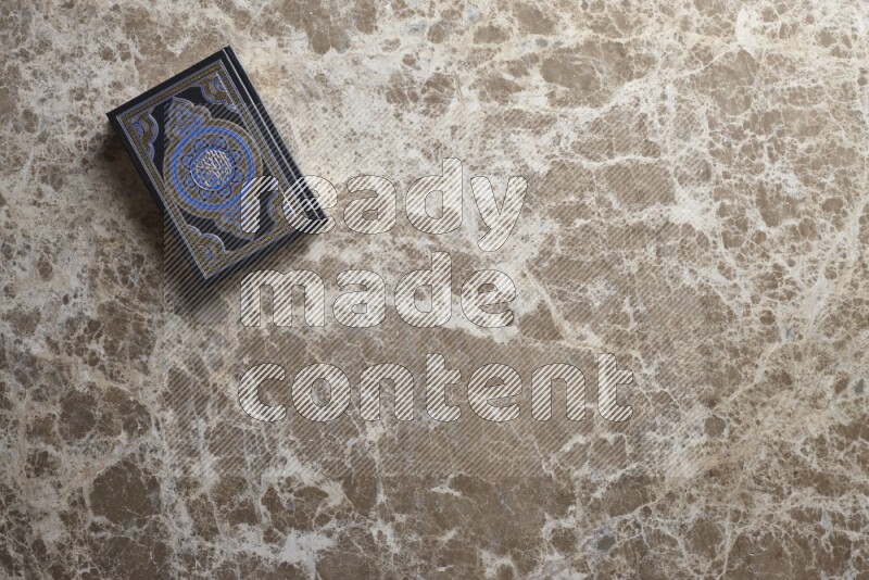 The holy Quran on beige marble background
