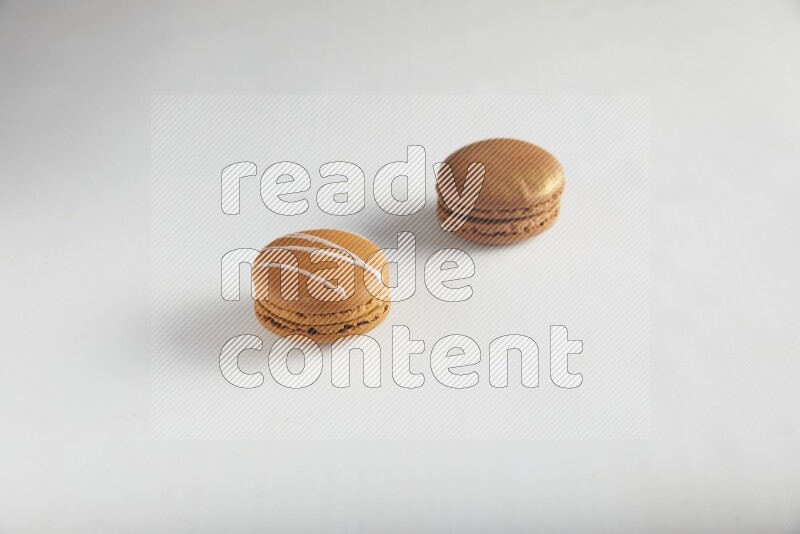 45º Shot of of two assorted Brown Irish Cream, and Brown Coffee macarons  on white background
