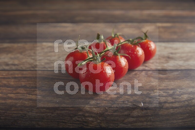 Red cherry tomato vein on a textured wooden background 45 degree