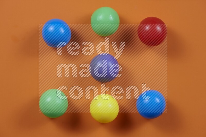Multicolored plastic balls on different colored backgrounds (kids toys)