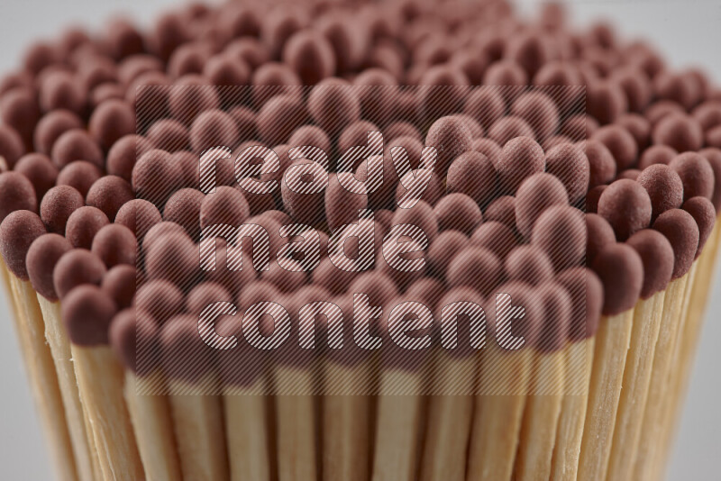 A close-up of a bundle of matches on grey background