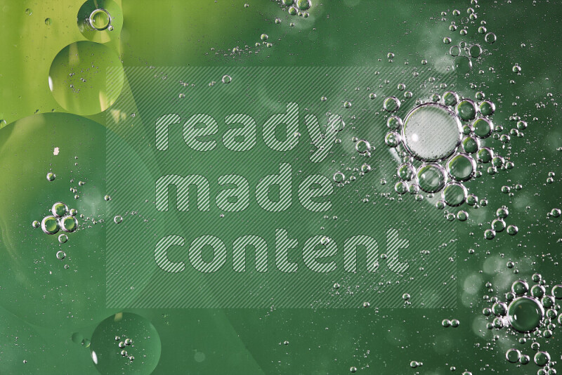 Close-ups of abstract oil bubbles on water surface in shades of green