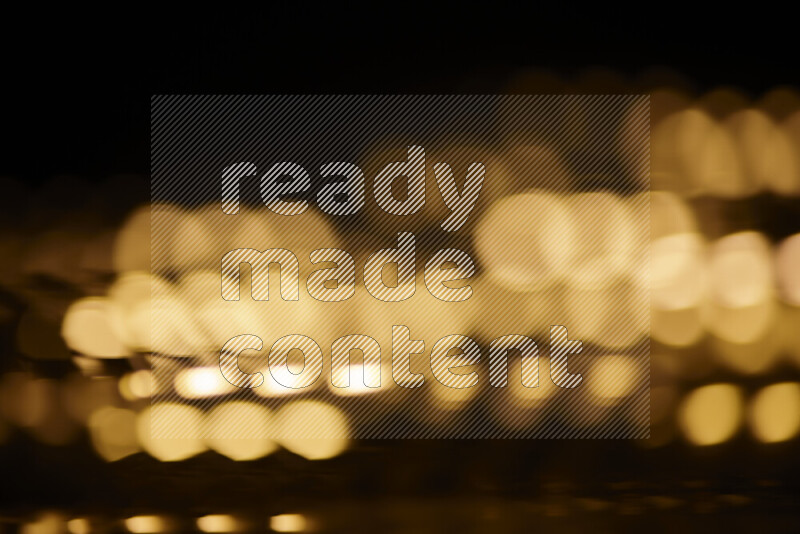 Light bulbs glowing against backdrop of golden bokeh