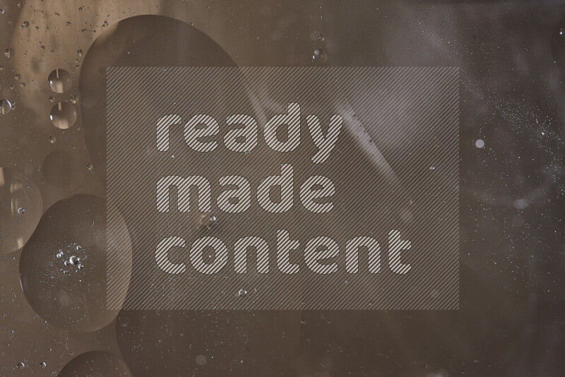 Close-ups of abstract oil bubbles on water surface in shades of brown