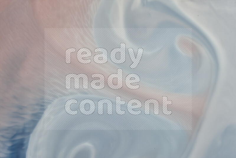 A close-up of abstract swirling patterns in blue, red and white