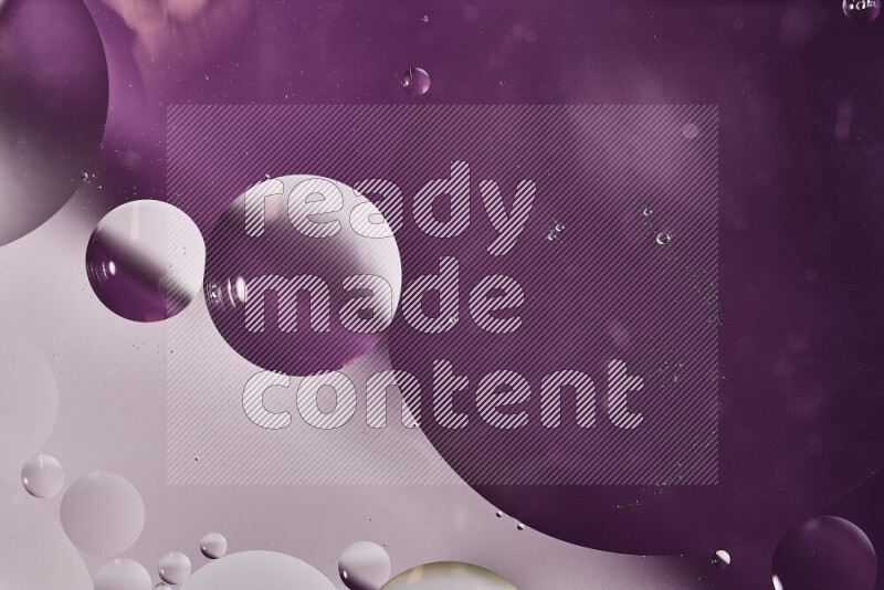 لقطات مقربة لفقاعات من الزيت على سطح الماء باللون الأبيض والأرجواني