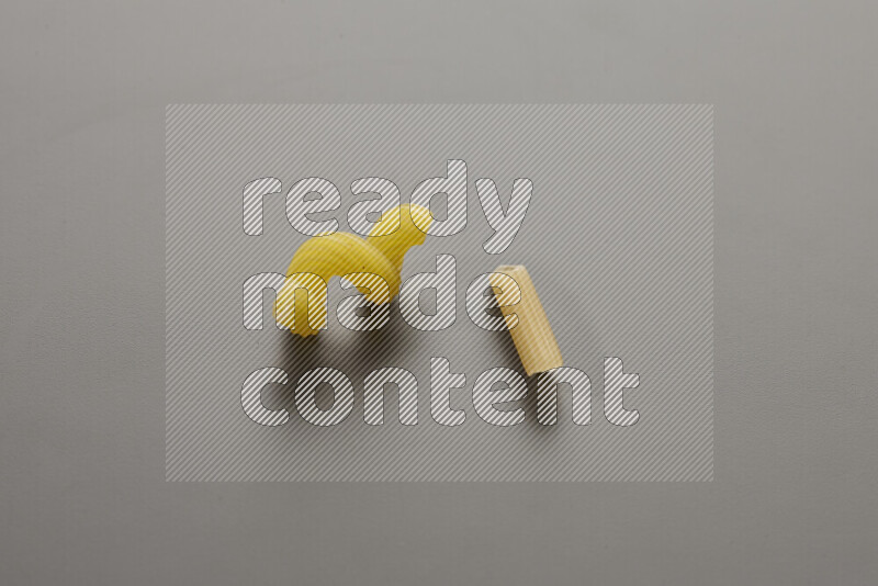 Twist pasta with other types of pasta on grey background