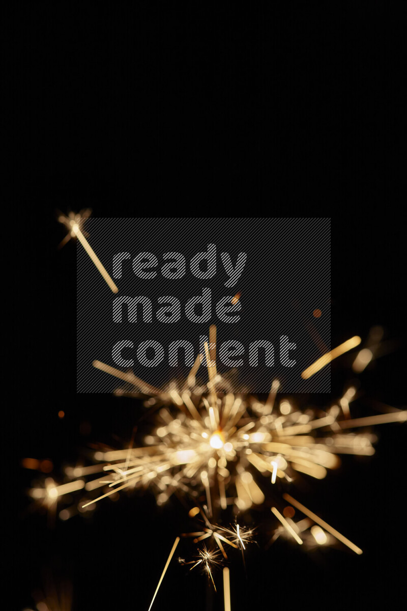 A close-up image of sparkler candle isolated on black background