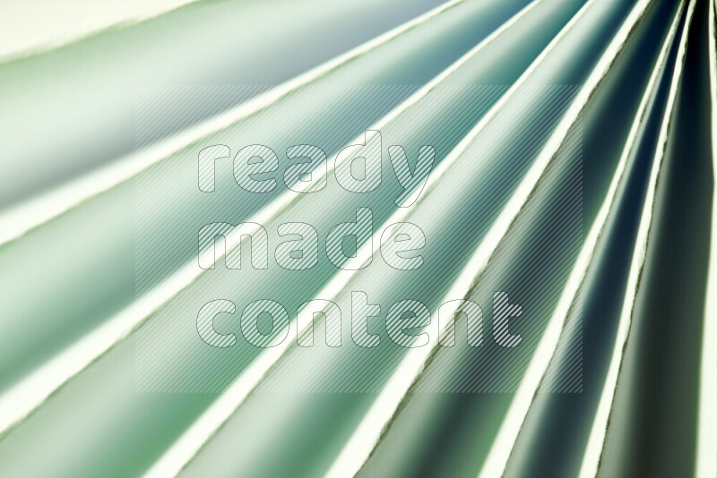 An image presenting an abstract paper pattern of lines in green and white tones