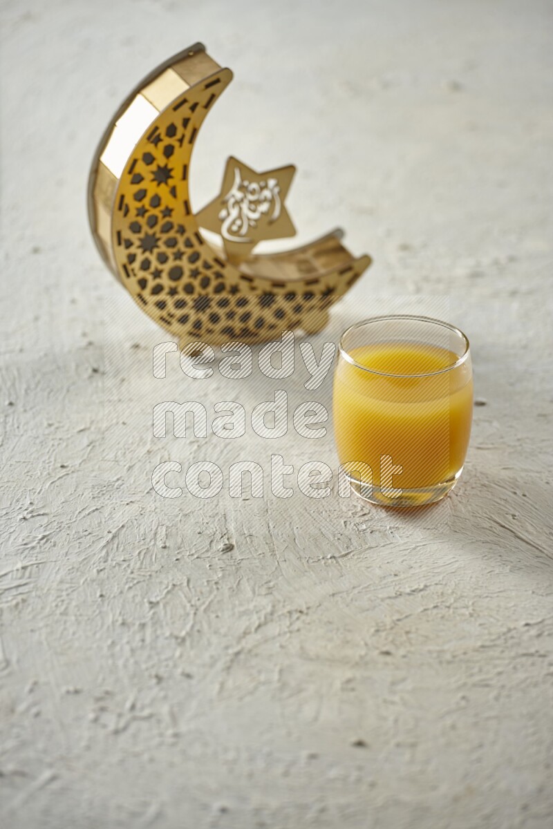 A wooden golden crescent lantern with different drinks, dates, nuts, prayer beads and quran on white background