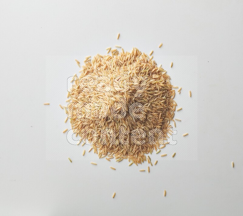 Top-view shot of long grain brown rice on white background