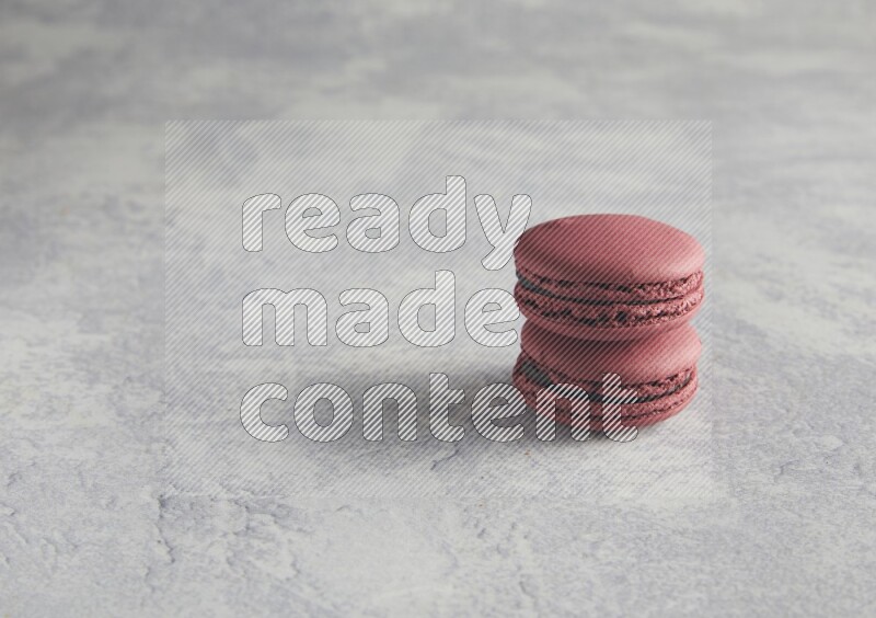 45º Shot of two Red Cherry macarons  on white  marble background