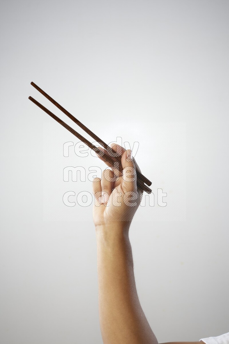 Male Hand Holding Chop Stick on white background