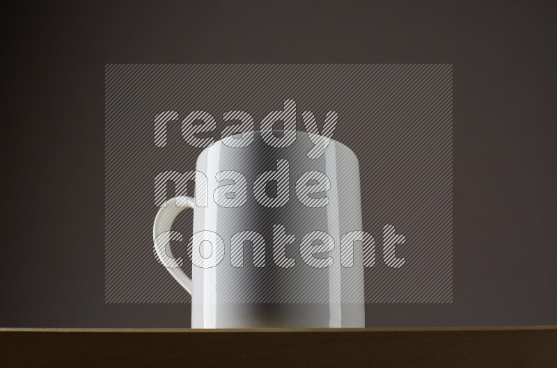 Low angle shot of a white cup on grey background