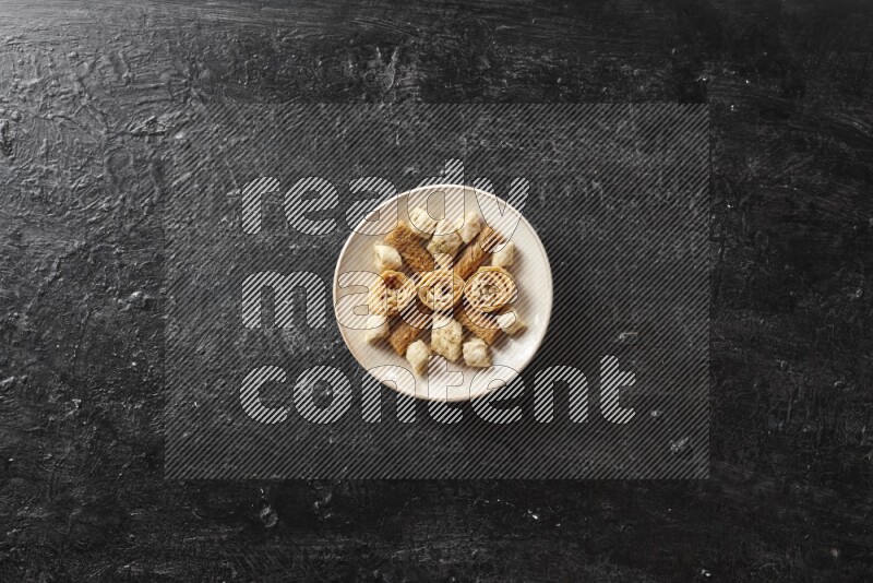 Oriental sweets in pottery plates in a dark setup