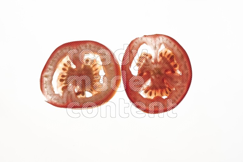 Tomatoes slices on illuminated white background