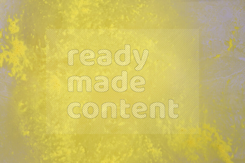 The image captures a dramatic splatter of yellow paint over a white backdrop