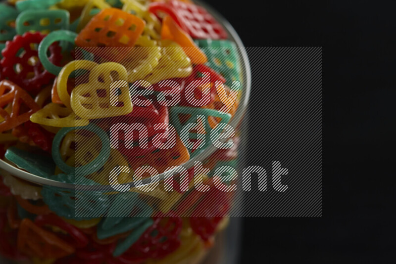 Snacks in a glass jar on black background