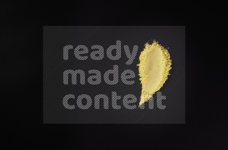 Yellow powder smears on black background