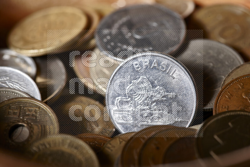 A close-ups of random old coins on black background